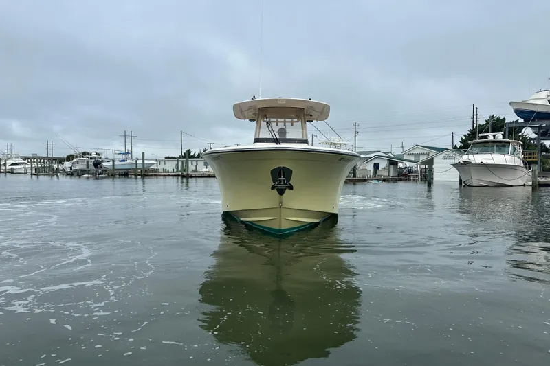 Slide: The Image of 2020 Grady-White Canyon 271 boat docked in a marina on a cloudy day. - 9