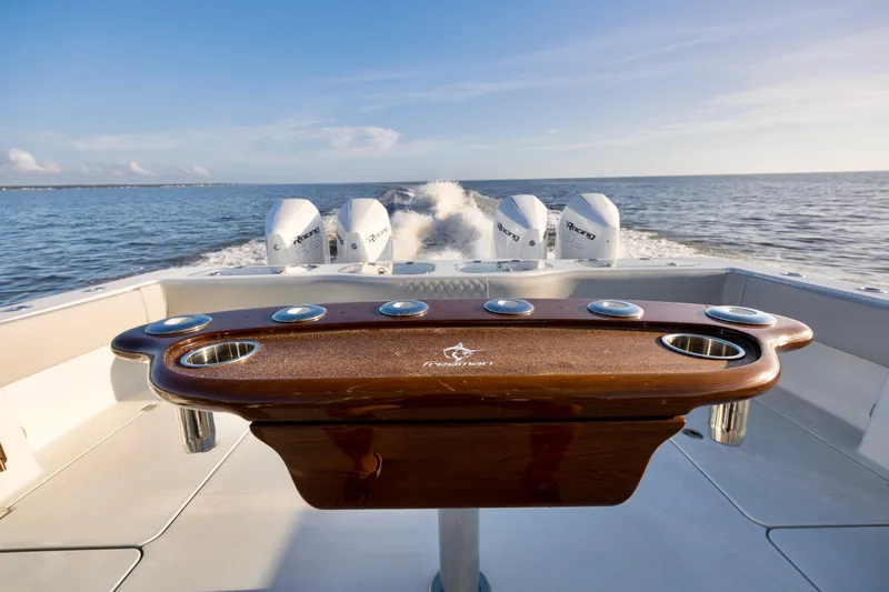 Slide: The Image of Freeman 47 boat, 2021 model, cruising with four powerful outboard engines on open water. - 10