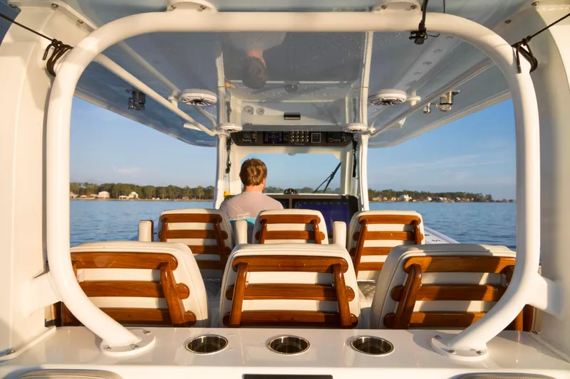 Slide: The Image of 2021 Freeman 47 boat interior with wooden seats, cruising on calm water. - 17