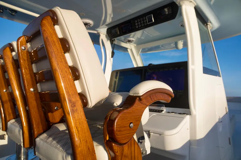 Slide: The Image of Luxury Freeman 47 boat interior, featuring elegant wooden seating and advanced navigation controls, 2021 model. - 18