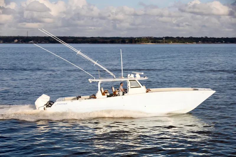 Slide: The Image of 2021 Freeman 47 boat cruising on open water under a cloudy sky. - 3