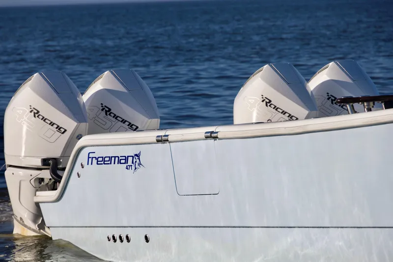 Slide: The Image of 2021 Freeman 47 boat with four powerful outboard engines on the water. - 7