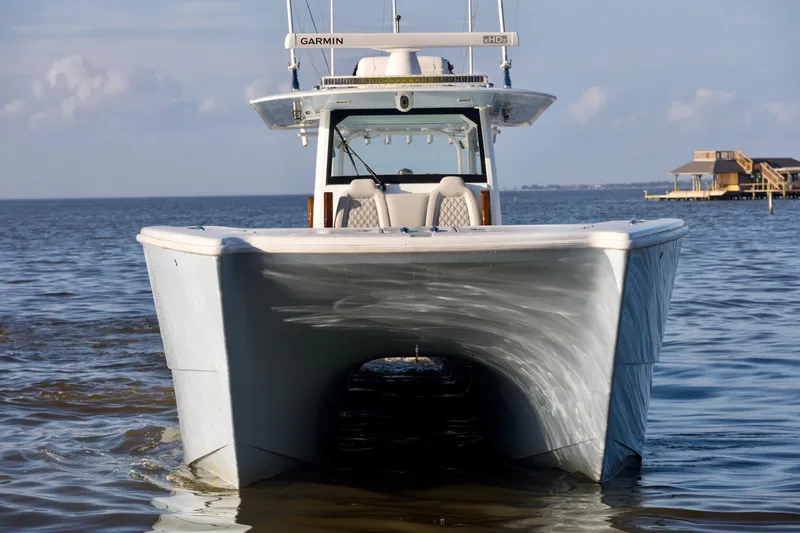 Slide: The Image of Front view of a 2021 Freeman 47 boat on calm water. - 8