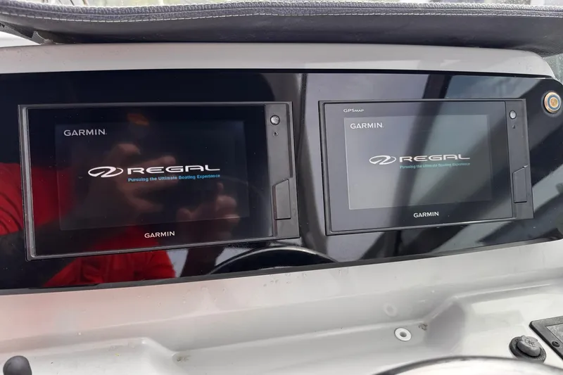 Slide: The Image of Dual Garmin displays on a 2021 Regal 26 XO boat dashboard. - 11