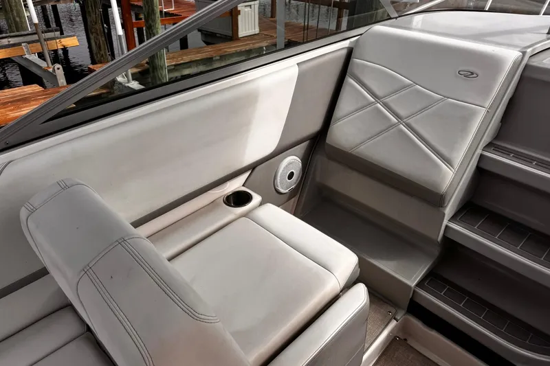 Slide: The Image of 2021 Regal 26 XO boat interior with gray seating and cup holder. - 13
