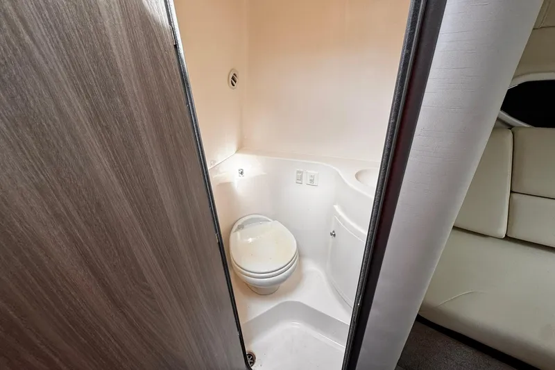 Slide: The Image of 2021 Regal 26 XO boat interior bathroom with compact toilet and modern design. - 20
