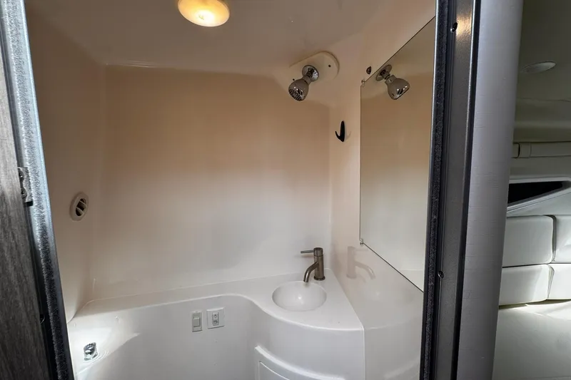 Slide: The Image of 2021 Regal 26 XO boat bathroom with sink, mirror, and lighting. - 21