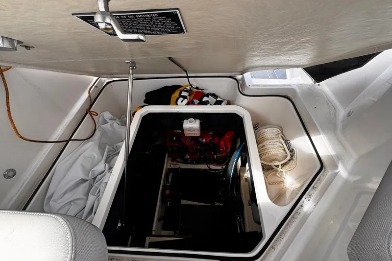 Slide: The Image of 2021 Regal 26 XO boat storage compartment with ropes and equipment. - 24