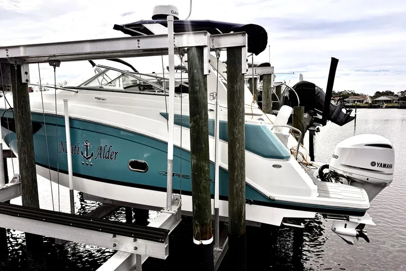 Slide: The Image of 2021 Regal 26 XO boat docked with Yamaha outboard motor. - 3