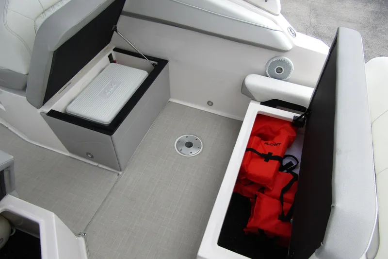Slide: The Image of 2021 Regal 26 XO boat interior storage with life jackets and cooler. - 38