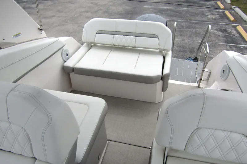 Slide: The Image of 2021 Regal 26 XO boat interior with white cushioned seating and modern design. - 39
