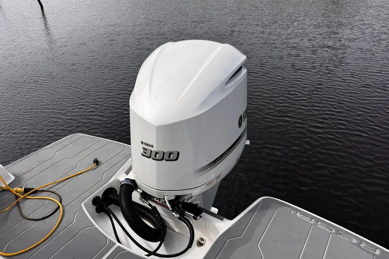 Slide: The Image of Yamaha 300 outboard motor on 2021 Regal 26 XO boat, docked on calm water. - 41
