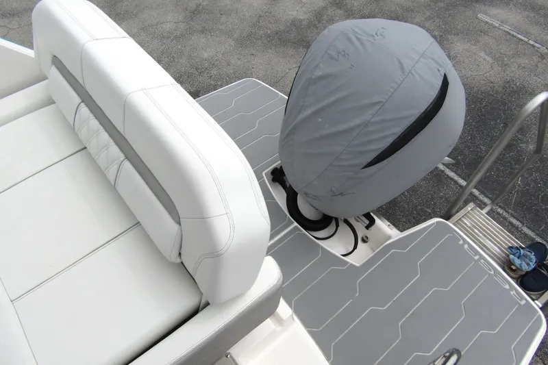 Slide: The Image of 2021 Regal 26 XO boat with covered outboard motor and cushioned seating. - 42