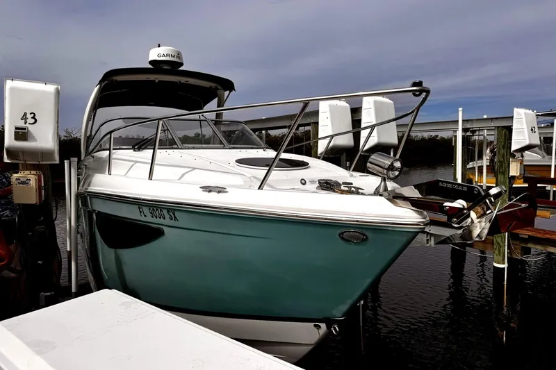 Slide: The Image of 2021 Regal 26 XO boat docked, featuring sleek design and Garmin equipment. - 6