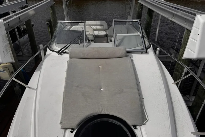 Slide: The Image of 2021 Regal 26 XO boat with open deck and seating, docked by the water. - 8