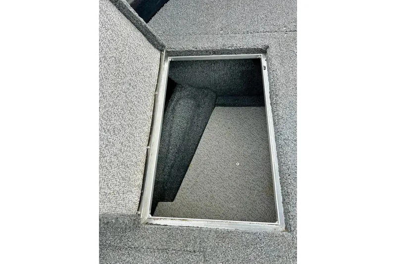 Slide: The Image of 2018 Crestliner CVN16 boat storage compartment with carpeted interior. - 15