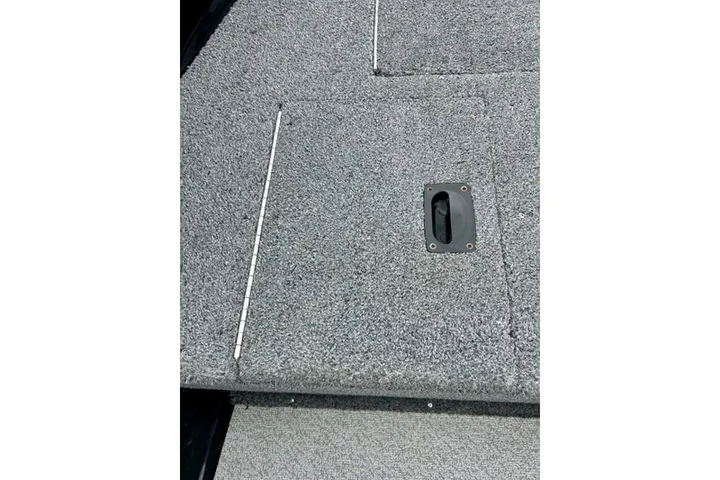 Slide: The Image of 2018 Crestliner CVN16 boat deck with gray carpet and storage hatch. - 18