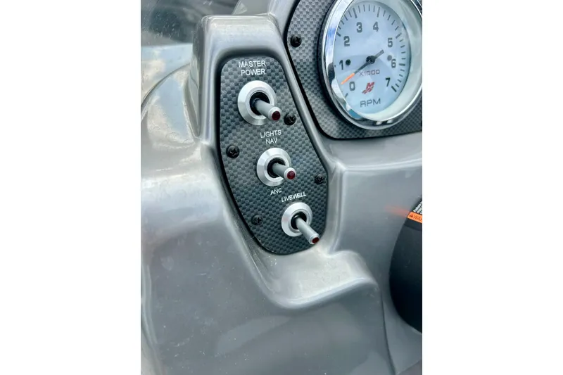Slide: The Image of Dashboard controls of 2018 Crestliner CVN16 boat with RPM gauge and switches. - 36