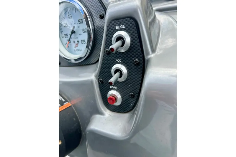 Slide: The Image of Dashboard controls of a 2018 Crestliner CVN16 boat, featuring switches and speedometer. - 37