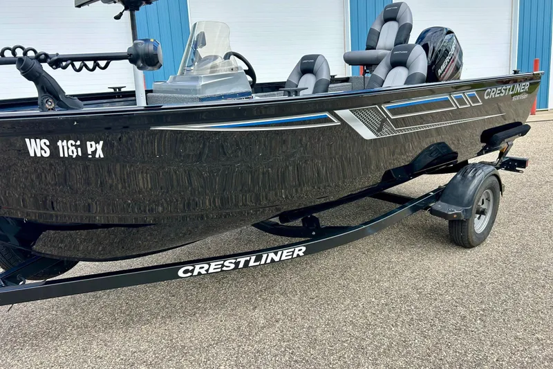 Slide: The Image of 2018 Crestliner CVN16 boat on trailer, featuring sleek black design and comfortable seating. - 44