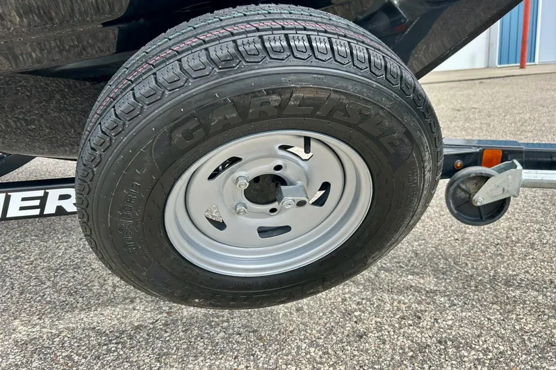 Slide: The Image of 2018 Crestliner CVN16 trailer tire with Carlisle branding on asphalt surface. - 7