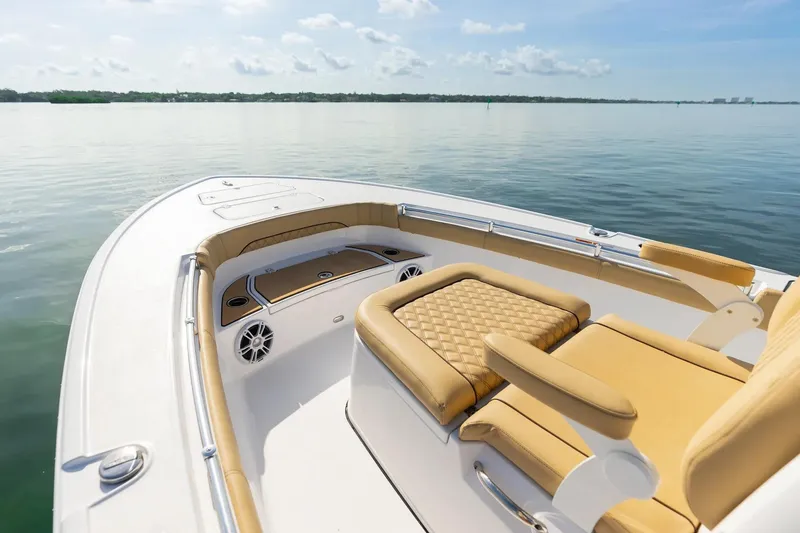 The Image of 2026 Sportsman Masters 267OE Bay Boat interior with tan seating on calm water. - 1