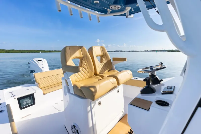 Slide: The Image of 2026 Sportsman Masters 267OE Bay Boat interior with luxurious seating and modern controls. - 11