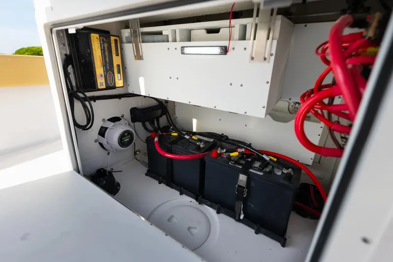 Slide: The Image of 2026 Sportsman Masters 267OE Bay Boat battery compartment with wiring and components. - 14