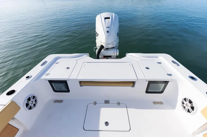 Slide: The Image of 2026 Sportsman Masters 267OE Bay Boat with outboard motor on calm water. - 16