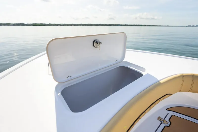 Slide: The Image of 2026 Sportsman Masters 267OE Bay Boat storage compartment open on calm water. - 2