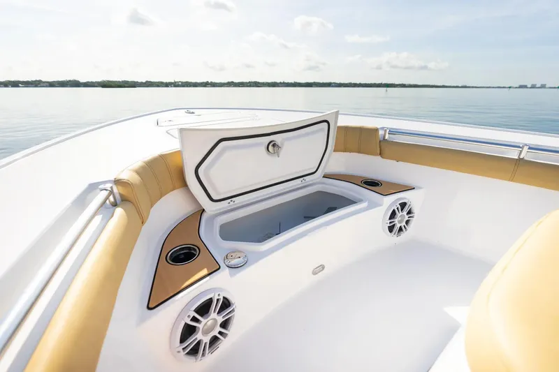Slide: The Image of 2026 Sportsman Masters 267OE Bay Boat interior with open storage compartment and speakers. - 3