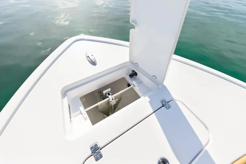 Slide: The Image of 2026 Sportsman Masters 267OE Bay Boat anchor compartment open on calm water. - 4