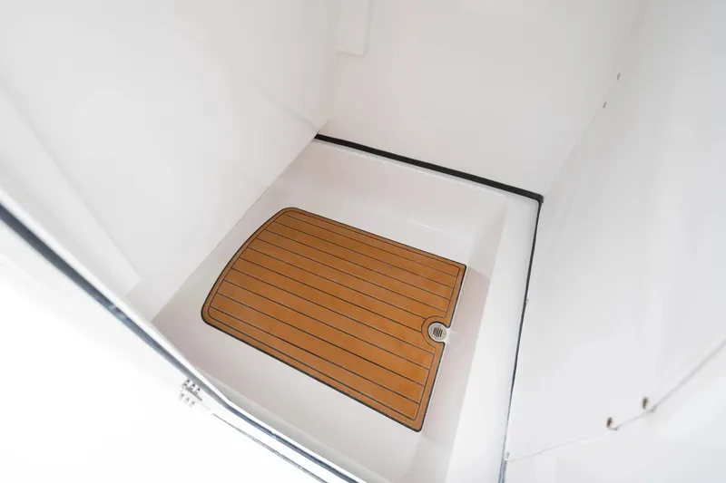 Slide: The Image of 2026 Sportsman Masters 267OE Bay Boat interior with teak-style flooring. - 9