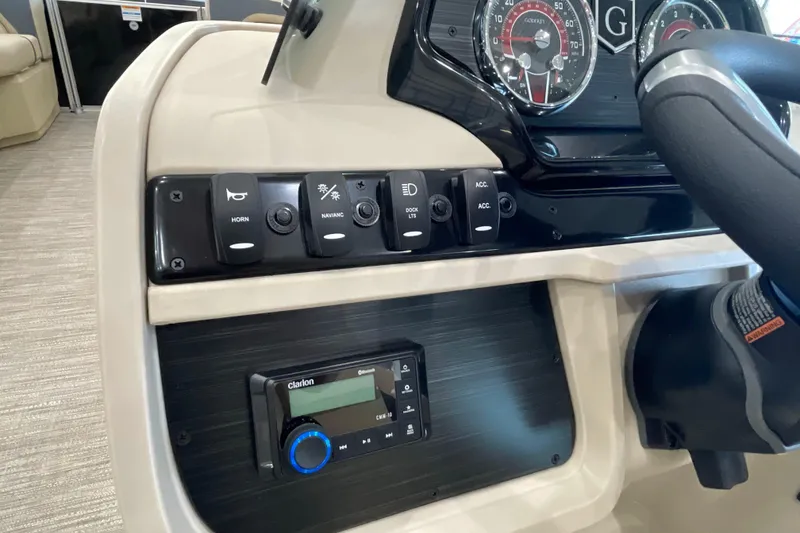 Slide: The Image of Control panel of 2026 Godfrey Sweetwater 2286 C boat with steering wheel and switches. - 11