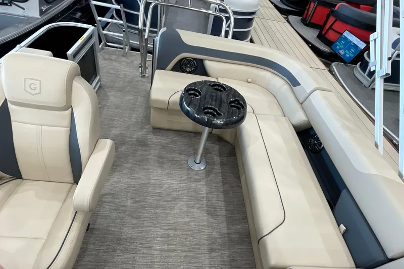 Slide: The Image of 2026 Godfrey Sweetwater 2286 C pontoon boat interior with beige seating and black table. - 13