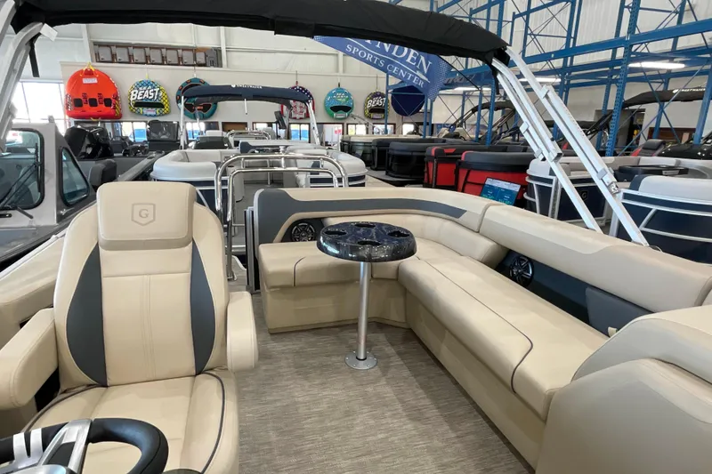 Slide: The Image of 2026 Godfrey Sweetwater 2286 C pontoon boat interior with beige seating and table. - 7