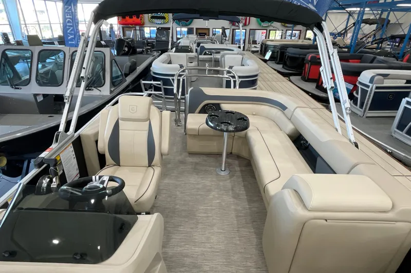 Slide: The Image of 2026 Godfrey Sweetwater 2286 C pontoon boat interior with plush seating and helm. - 8