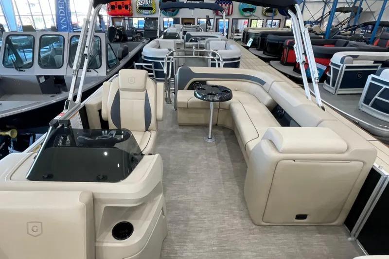 Slide: The Image of 2026 Godfrey Sweetwater 2286 C pontoon boat interior with beige seating and helm. - 9