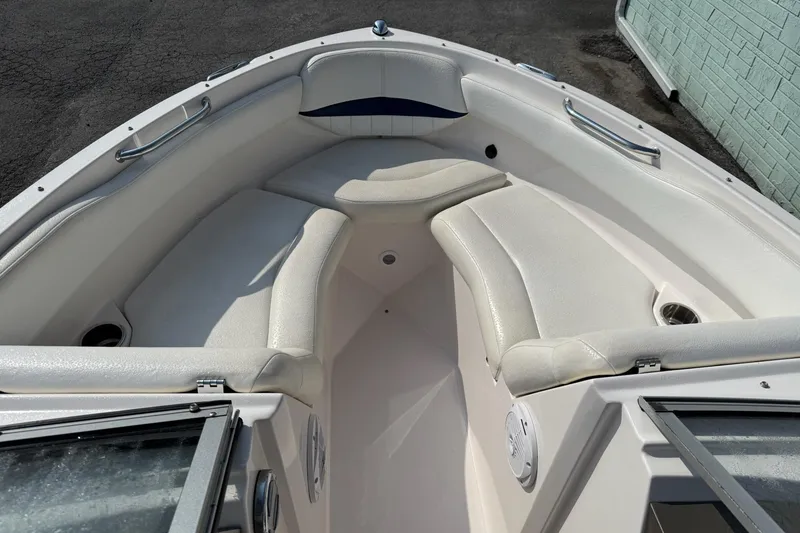 Slide: The Image of 2006 Regal 2000 Bowrider boat interior with white seating and stainless steel handrails. - 4