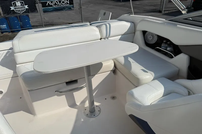 Slide: The Image of 2006 Regal 2000 Bowrider interior with white seating and table, showcasing comfort and style. - 6