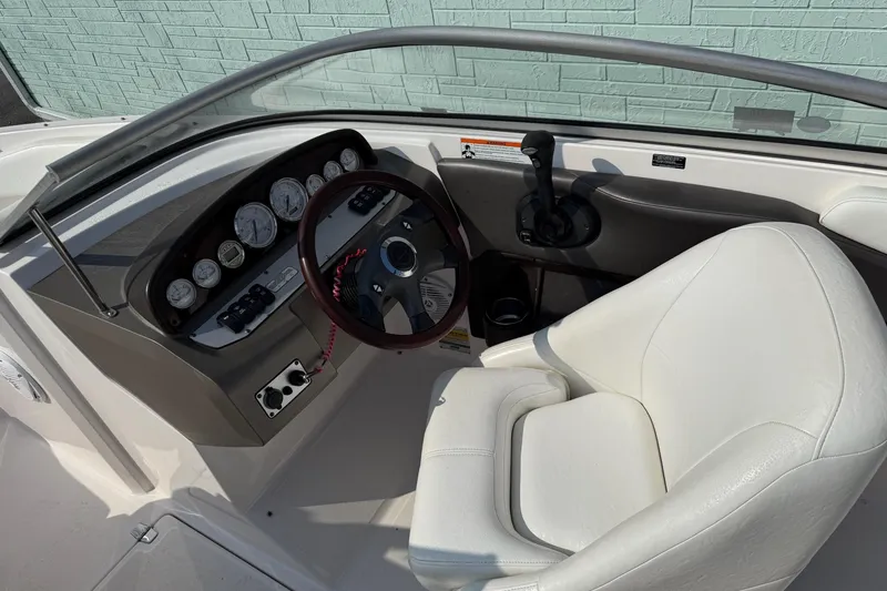 Slide: The Image of Interior of a 2006 Regal 2000 Bowrider boat with steering wheel and gauges. - 7