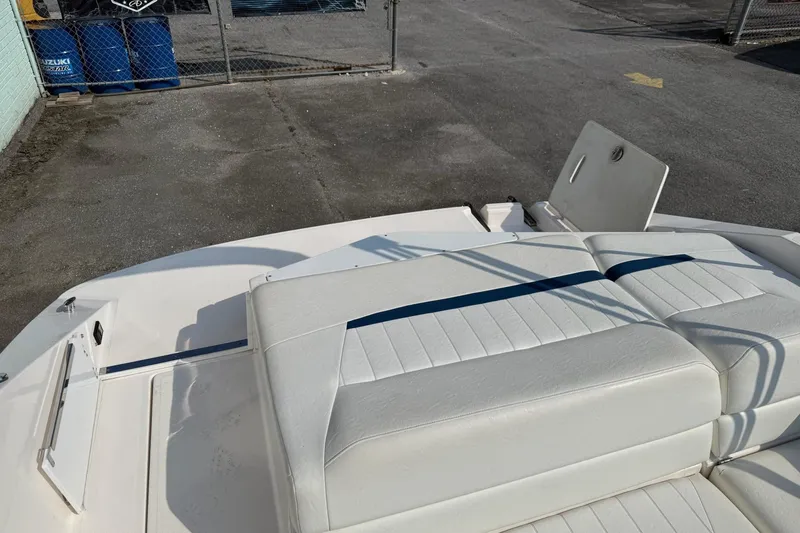 Slide: The Image of 2006 Regal 2000 Bowrider boat interior with white seating and storage compartment. - 8