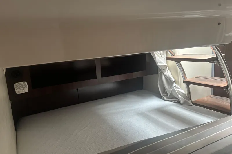 Slide: The Image of Interior cabin of 2016 Regal 28 Express boat with bed and wooden steps. - 10