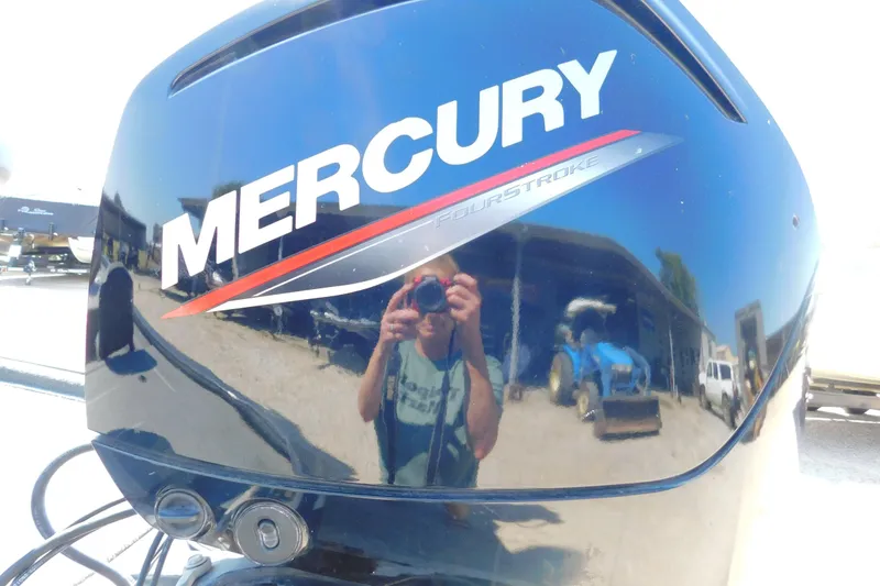 Slide: The Image of Mercury FourStroke engine on 2022 Tracker Pro Team 175 boat, reflecting surroundings. - 10