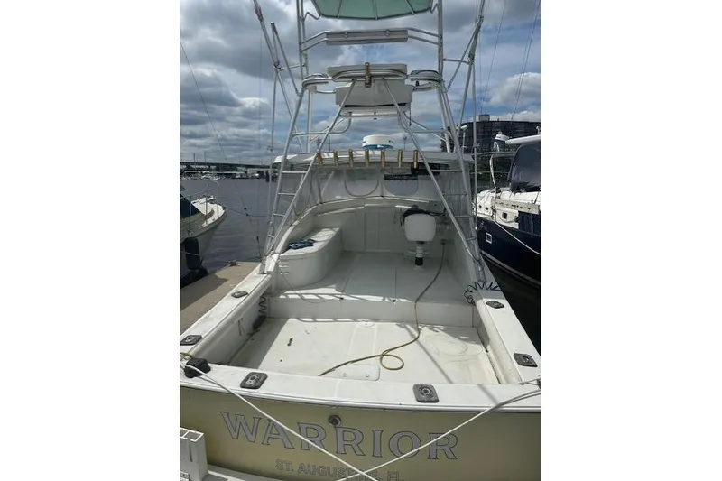 Slide: The Image of 2002 Bob Sherbert and Lou Rambo Custom Sportfish boat docked, rear view, named "Warrior." - 11