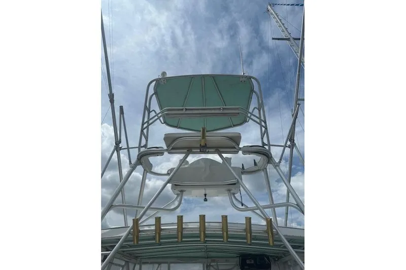 Slide: The Image of 2002 Bob Sherbert and Lou Rambo Custom Sportfish tower against a cloudy sky. - 12