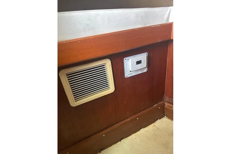 Slide: The Image of Wooden interior of 2002 Bob Sherbert and Lou Rambo Custom Sportfish with vent and control panel. - 5