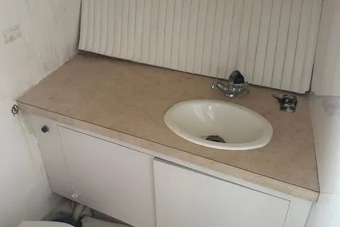 Slide: The Image of 2002 Bob Sherbert and Lou Rambo Custom Sportfish bathroom sink with beige countertop. - 8