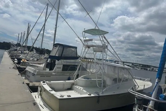 Slide: The Image of Docked 2002 Bob Sherbert and Lou Rambo Custom Sportfish boat under cloudy sky. - 9