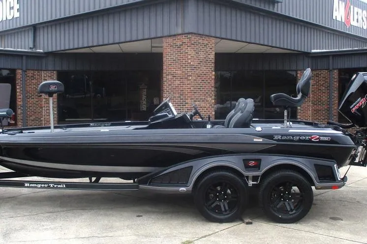 The Image of 2026 Ranger Z520R Cup-Equipped boat, sleek black design, parked outside a brick building. - 1